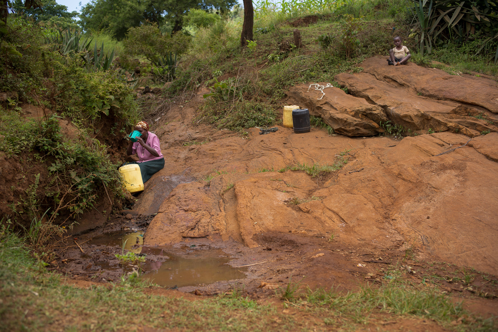 woman-collecting-water-from-creek