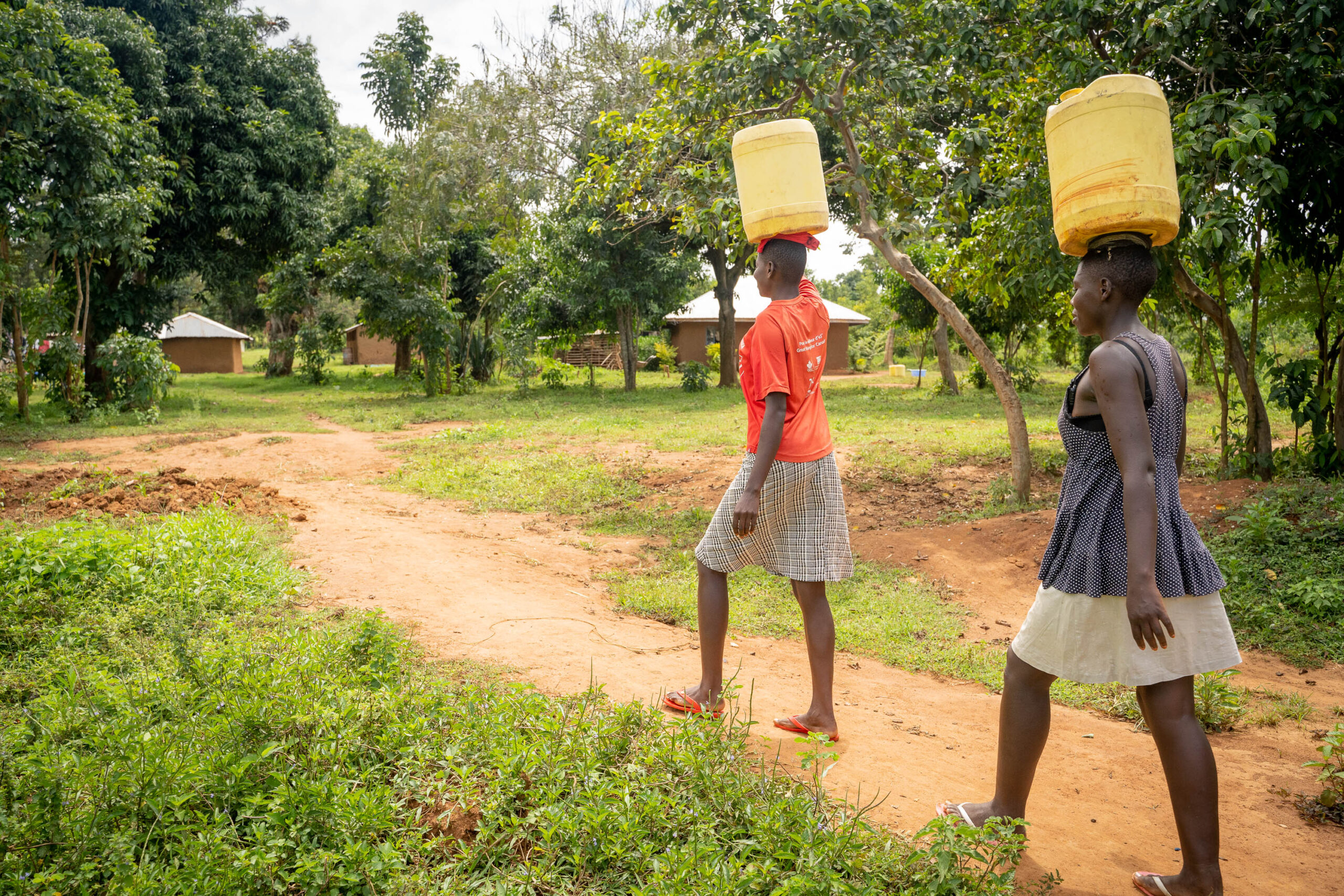 Women walking with jerrycans on their heads