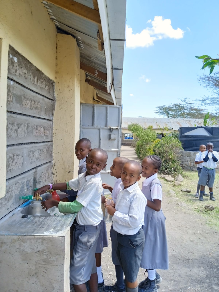 Kwa katheke primary students fetching drinking water from the newly installed rain water catchment & UV filtration system - 1st February 2023